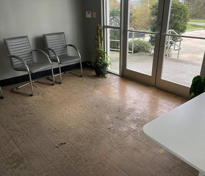 office foyer with debris from flood on flooring 